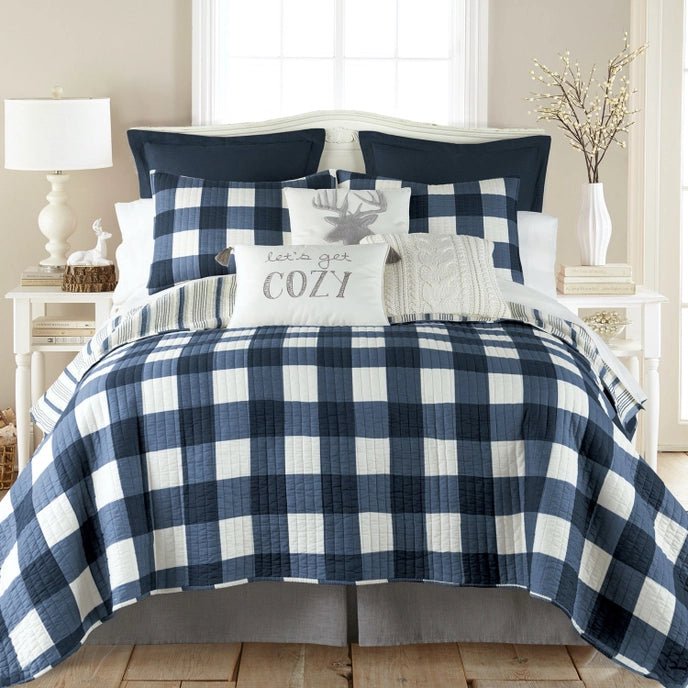 Bed with blue and white checkered bedding in a bedroom setting.