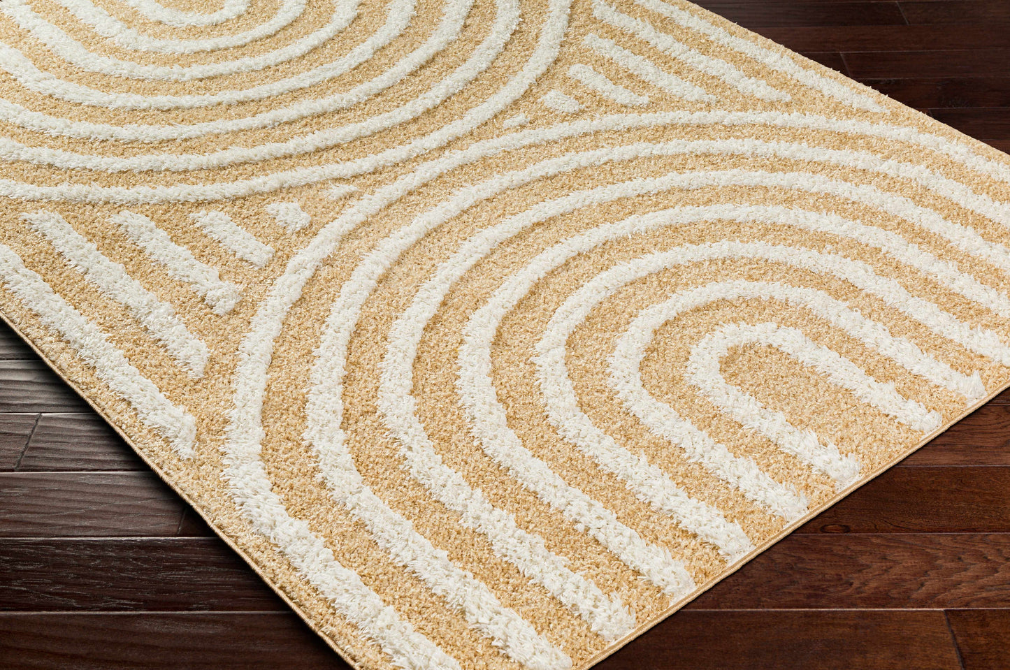 Close-up of Arnel Beige Area Rug on dark wood floor, showcasing plush 0.31-inch pile and soft geometric texture.