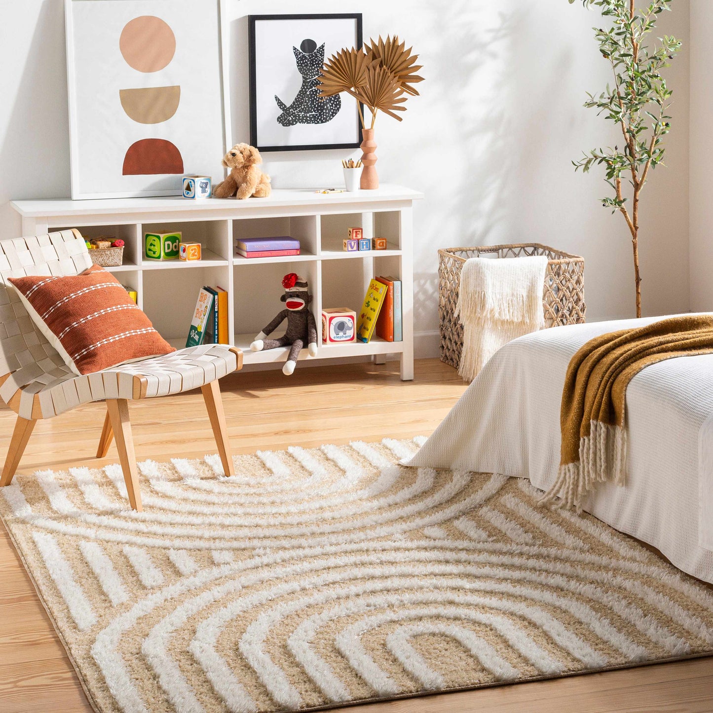 Arnel Beige Area Rug in a cozy bedroom with mid-century decor, adding warmth and texture to the space with its modern design.