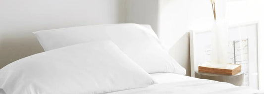 Luxury bamboo sheet sets styled in a bright, serene bedroom