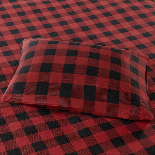 Red and black buffalo check 100% cotton flannel sheet set styled for a cozy winter bedroom