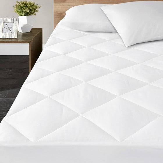 Close up of the quilting and stitched edge on the hand sewn shallow pocket mattress pad