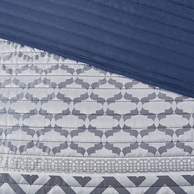 Close-up of Universal V Berth Navy Blue Bennett Quilt Cover Set fabric showing intricate grey and navy geometric stitching. Premium yacht bedding detail.