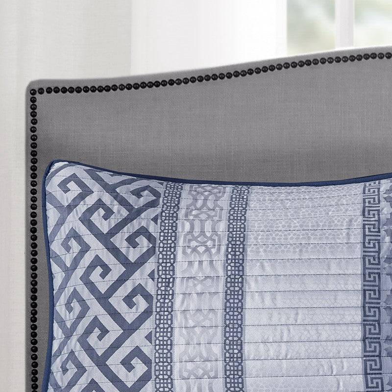 Detail of pillow from Universal V Berth Navy Blue Bennett Quilt Cover Set with navy piping and patterned panels. Elegant yacht bedding accessory.