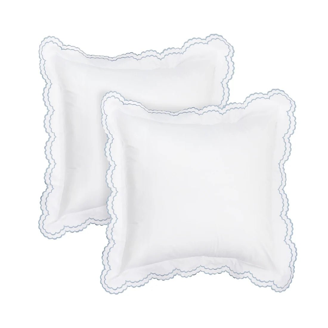 Two white square decorative pillows with scalloped edges, arranged overlapping on a plain white background.