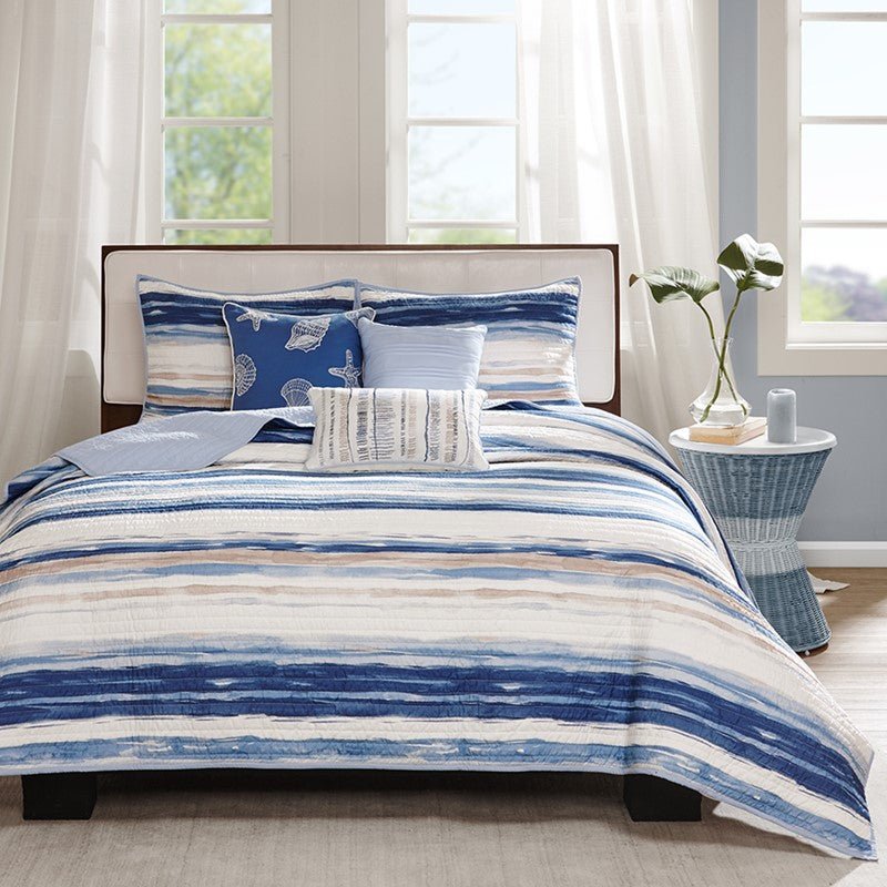 Marina navy nautical comforter and quilt set layered on a coastal bed