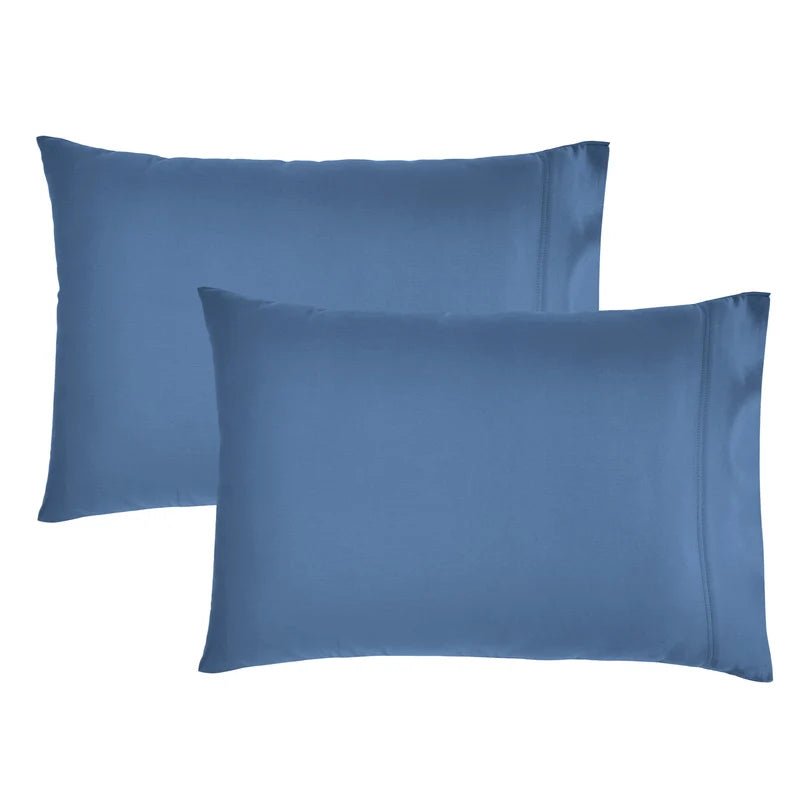 Two blue satin pillowcases on a white background