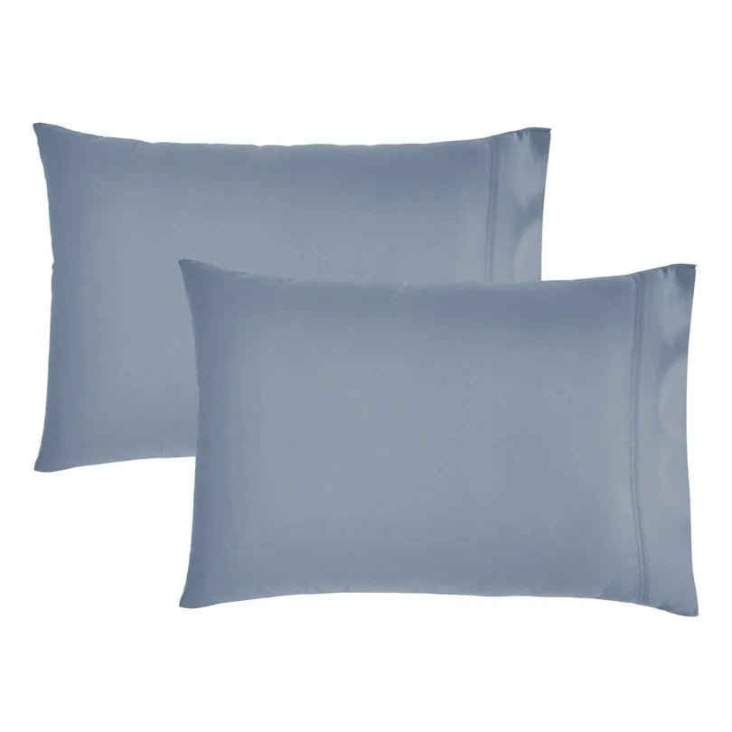 Two dusty blue pillowcases shown on a plain white background.