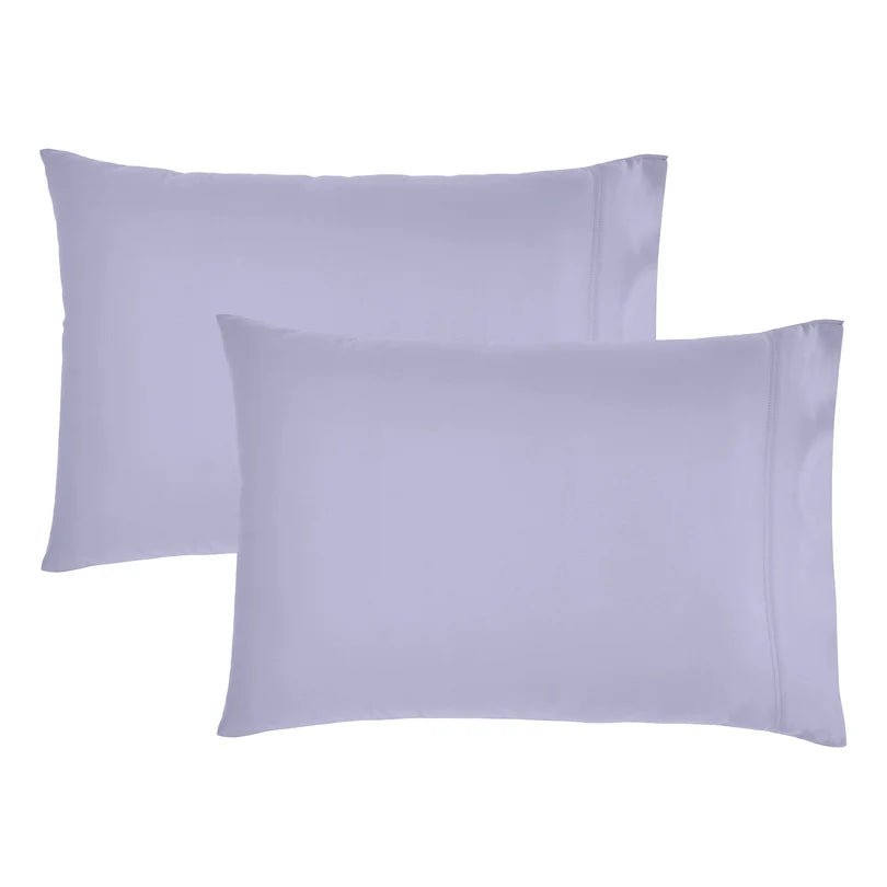 Two plain pillowcases in a very light cool lavender or pale periwinkle color, shown on a clean white background.
