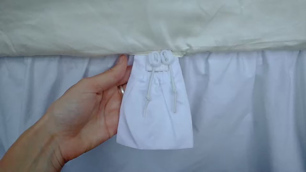 Load video: Looping close-up demonstration of CinchFit’s durable cord elastic adjusting around a fitted sheet to fit a mattress.